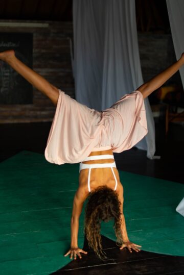 piera maria doing a yoga handstand in here studio